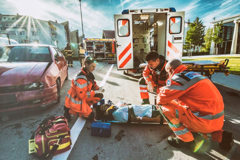 man getting help from paramedics after a car accident