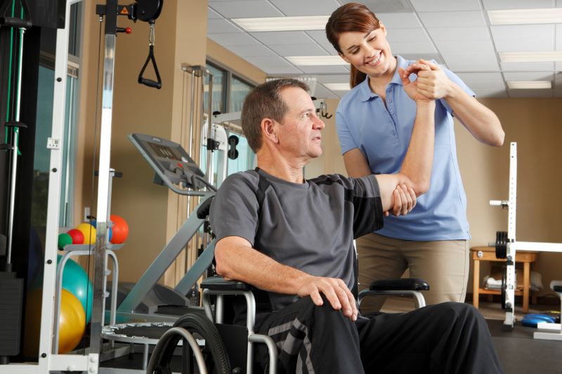 man with a spinal cord injury receiving physical therapy