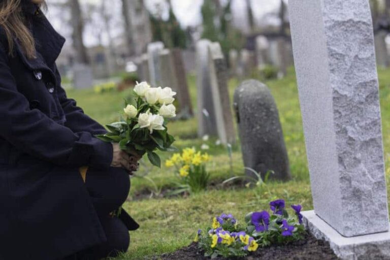 woman grieving over a loved ones grave