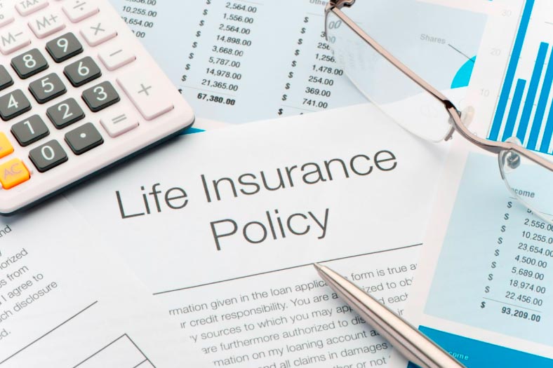 Life Insurance Policy Documents A Calculator And Glasses