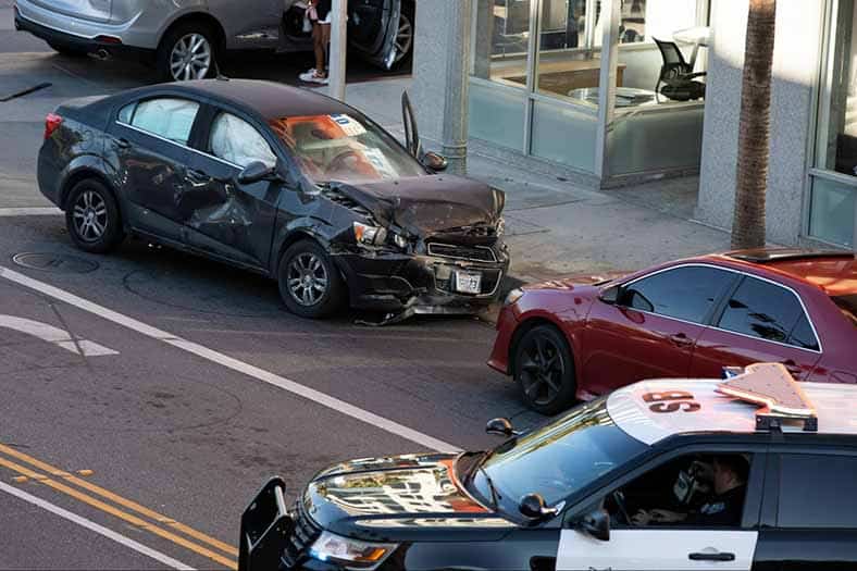 police officer arriving to scene of two-car accident