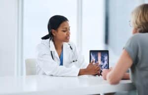 Doctor showing patient an exam of a spinal cord injury