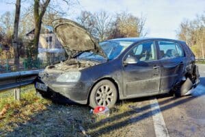 car crashed into a guardrail with hood open