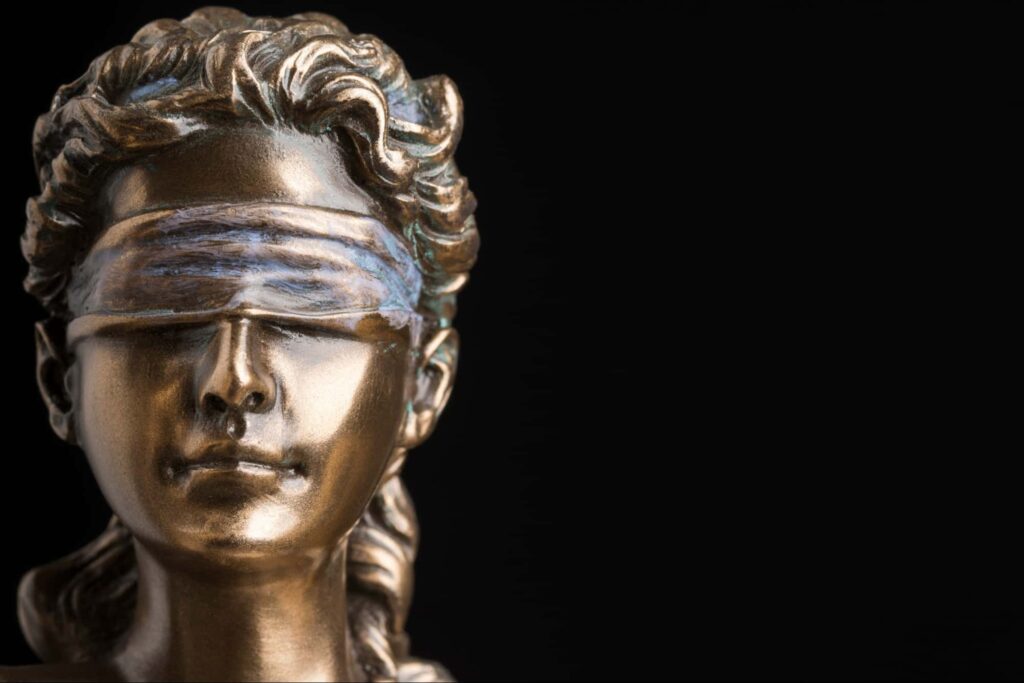A close up view of the head of the Lady Justice statue that is on a wrongful death lawyer's desk.