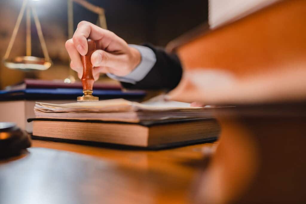 A birth injury lawyer at their desk stamping paperwork.