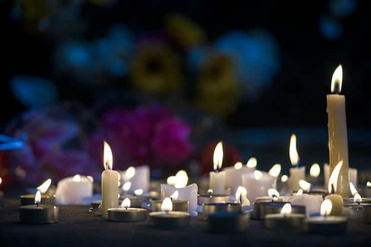 Many lit candles in memorial to someone who suffered a wrongful death. 