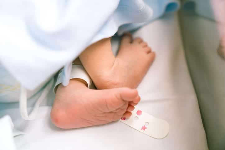 Focus is on a newborn's feet.