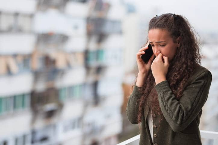A woman upset while on the phone. 